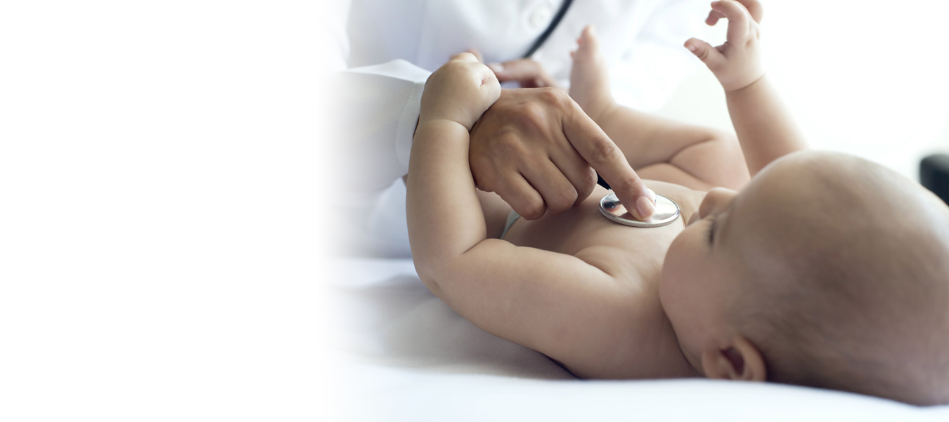 Physician using stethoscope on baby